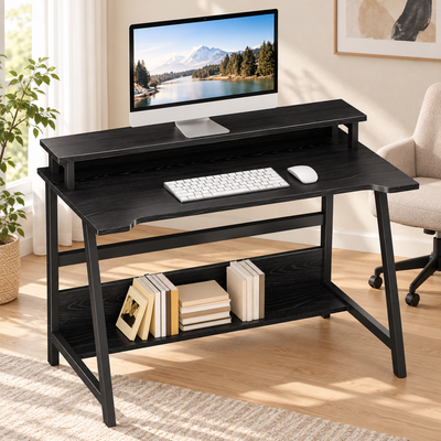 Black compact computer desk with storage shelves in a bright home office